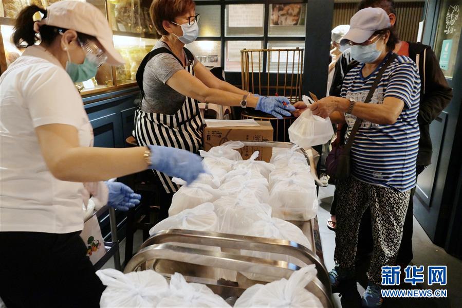 在香港銀杏館餐廳油麻地店,義工發放盒飯(5月7日攝)。 新華社記者 王申 攝