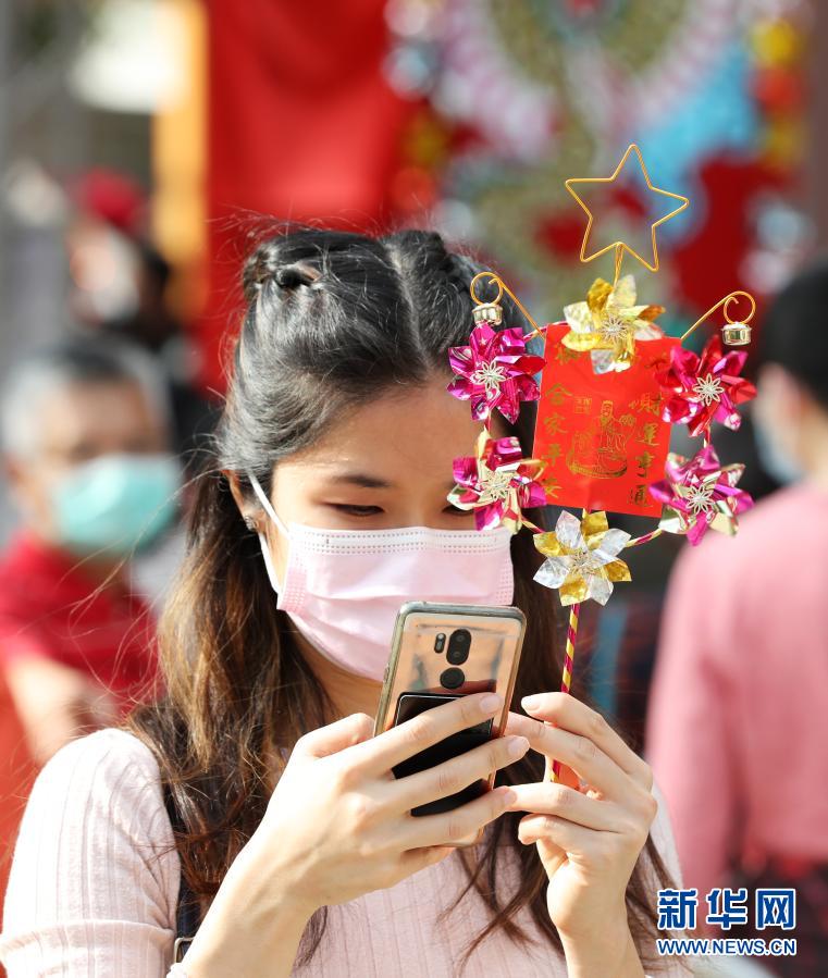 2月12日,在香港黄大仙祠,香港市民戴口罩祈福。新华社记者 李钢 摄