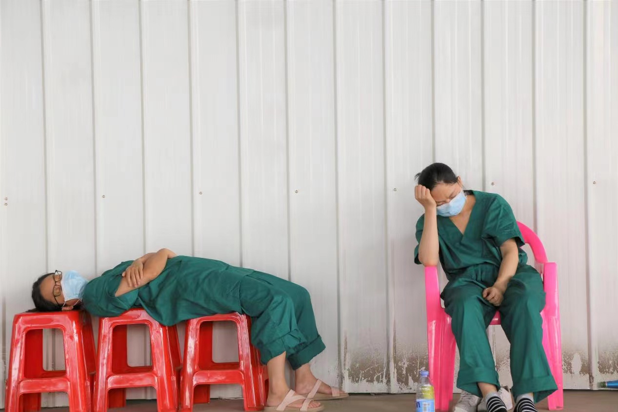 医护人员在塑料凳上短暂休息.