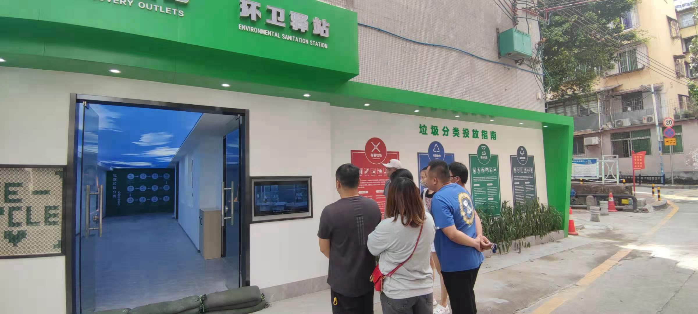 02.门外屏幕播放的正是垃圾分类宣传知识视频,吸引着过往行人不时驻足观看。